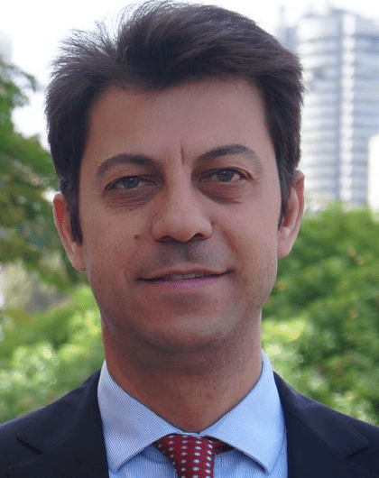 photo of Bassam Farah in front of a blurry city background