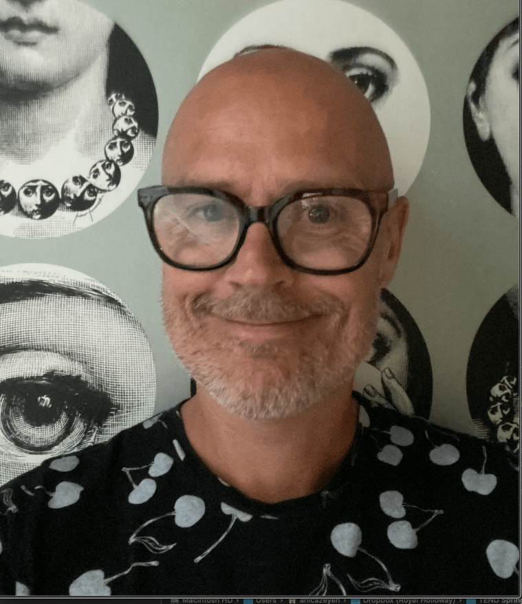 photo of Dan Goodley in front of a background with circular photos of people