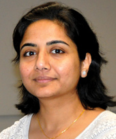 photo of Nidhi Singal in front of a grey background. she looks slightly to the left