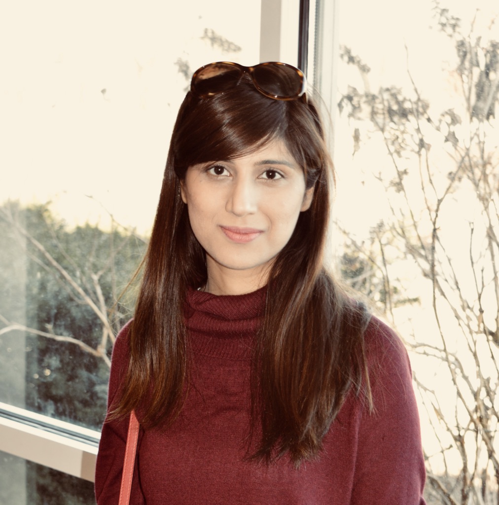 upper body shot of Huda Masood wearing a black top in front of a window