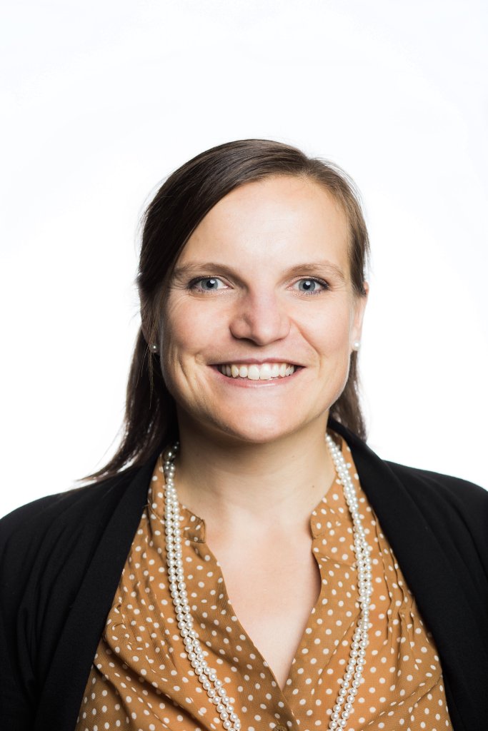 Head shot of Amanda Hancoc wearing a golden pokedot top and black blazer in front of a white background