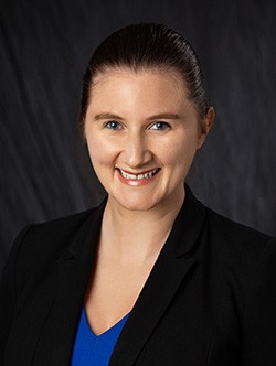 photo of Stella Seyb who wears a black top and is in front of a black background