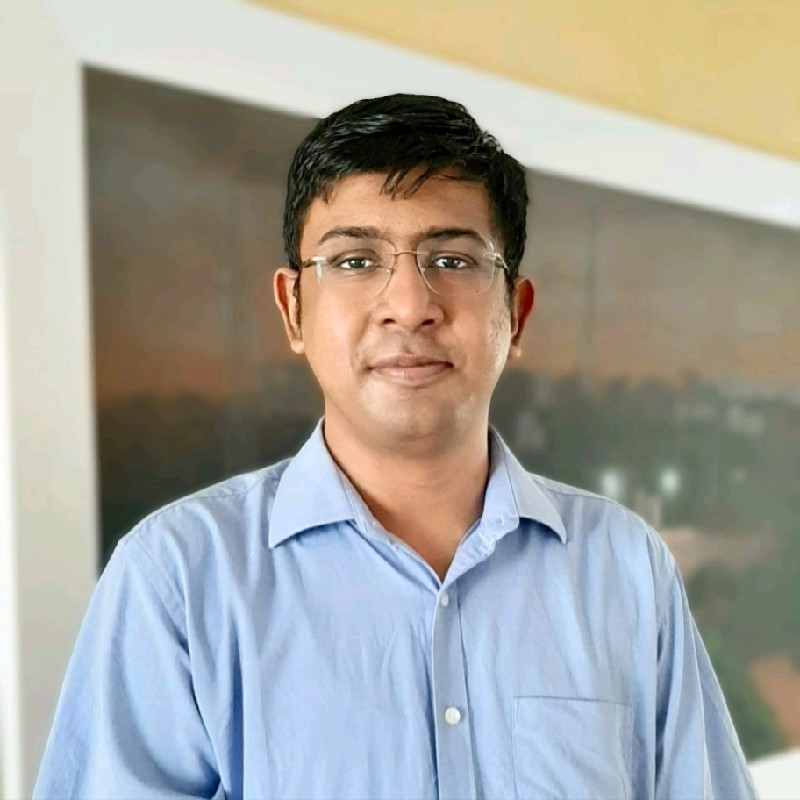 photo of Siddhartha Saxena. He has short dark hair and wears glasses. He also wears a blue shirt