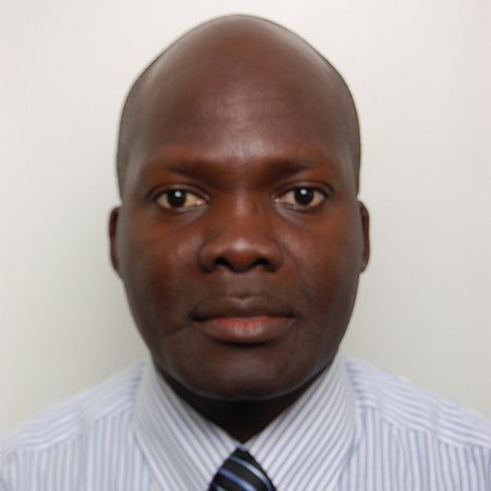 photo of Constantine Steven Loum, a black bold man wearing a dress shirt