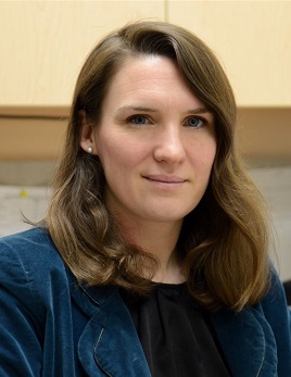 headshot of Arleen Macdougall, a white woman with long brown hair