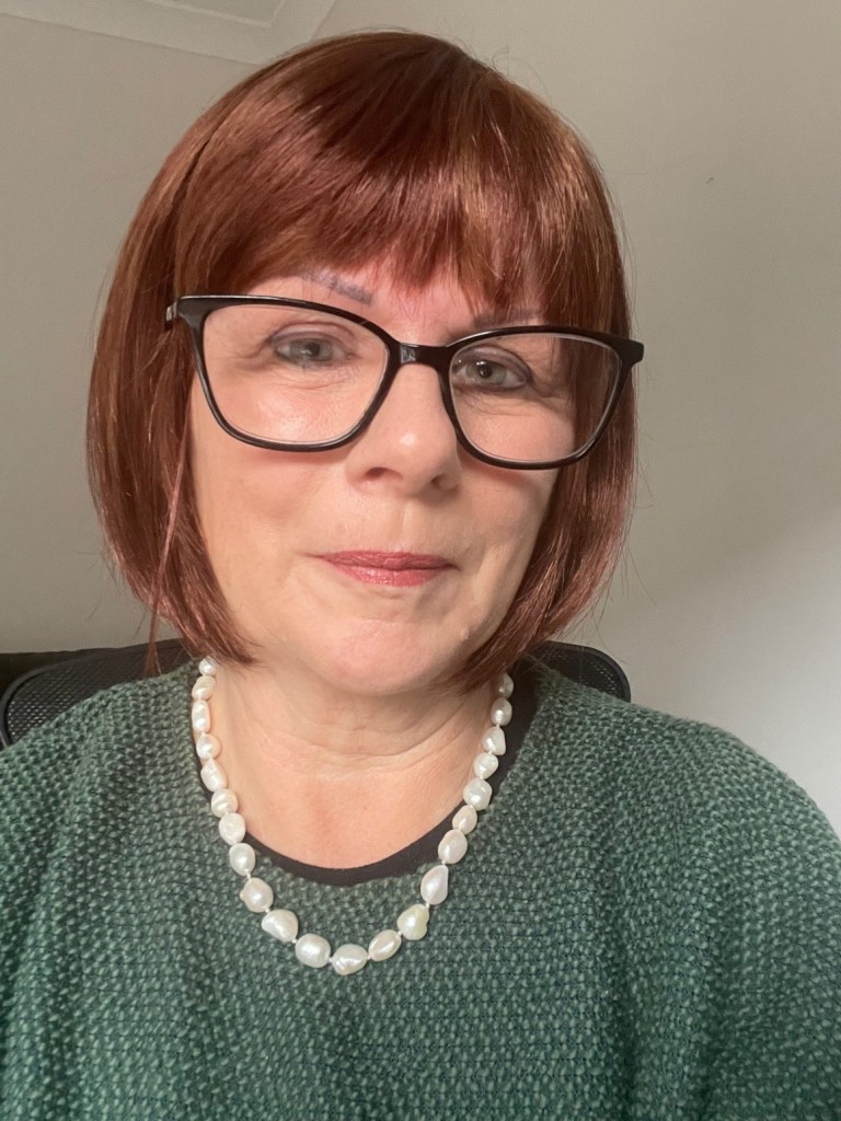 headshot of Karen Willis who has a bob hair style with dark hair and wears glasses