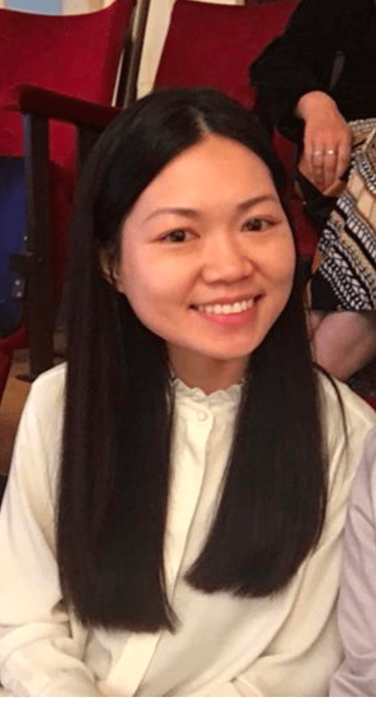 headshot of Dong Lin, an Asian woman with long black hair wearing a white top