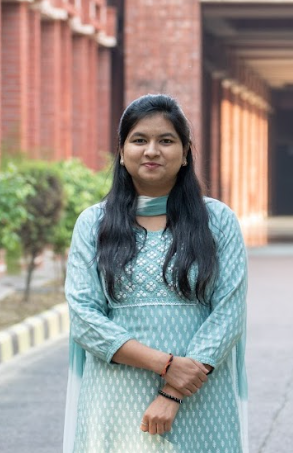 photo of Akshata who is an Indian woman with long dark hair. She wears a light blue traditional Indian attire